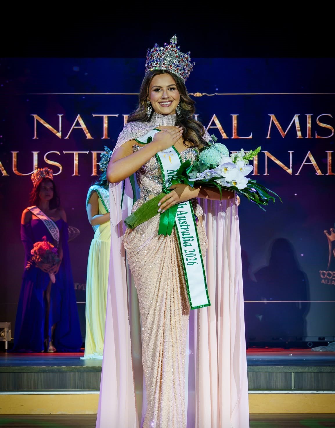Helena Ristevski, Miss Earth Australia 2026, smiling in her crown and sash on the stage of the national finals